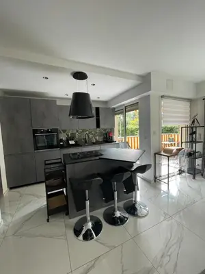 a kitchen with a black island in a room at Oasis by L'Oliveraie in Cannes