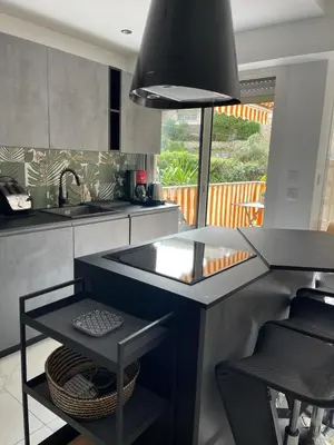 a kitchen with a sink and a counter with a table at Oasis by L'Oliveraie in Cannes