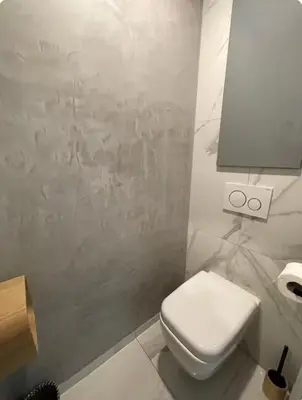 a white bathroom with a toilet and a lamp at Oasis by L'Oliveraie in Cannes