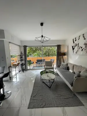 a living room with a couch and a table at Oasis by L'Oliveraie in Cannes