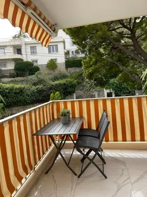a table and a chair on a balcony at Oasis by L'Oliveraie in Cannes