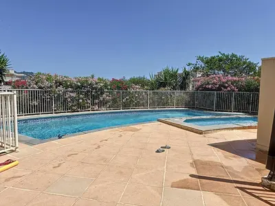 a swimming pool in a yard with a fence at 2 bedroom with pool 2 bathrooms 339 in Cannes