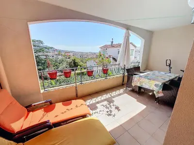 a living room with a couch and a large window at 2 bedroom with pool 2 bathrooms 339 in Cannes