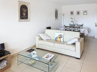 a living room with a white couch and a glass table at 2 bedroom with pool 2 bathrooms 339 in Cannes