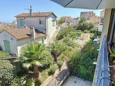 a view of a street with palm trees and buildings at 2 bedroom with pool 2 bathrooms 339 in Cannes
