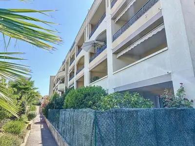 an apartment building with a fence in front of it at 2 bedroom with pool 2 bathrooms 339 in Cannes