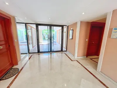 an empty hallway with glass doors in a building at 2 bedroom with pool 2 bathrooms 339 in Cannes