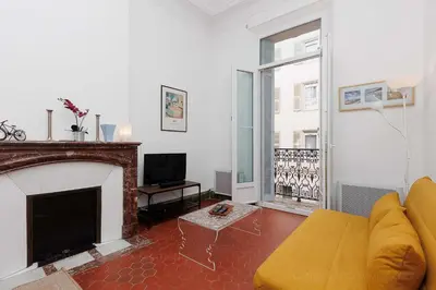 a living room with a couch and a fireplace at Bessons in Cannes