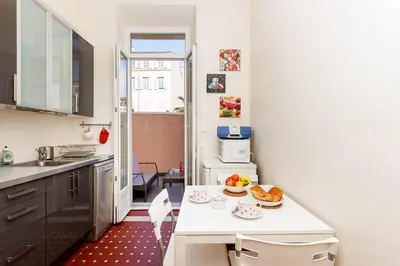 a small kitchen with a white table with food on it at Bessons in Cannes
