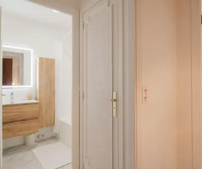 an open door to a bathroom with a sink at Le Navarre By ApiRent #Terrasse #Ascenseur #Wifi in Cannes