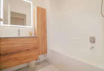 a bathroom with a sink and a mirror at Le Navarre By ApiRent #Terrasse #Ascenseur #Wifi in Cannes