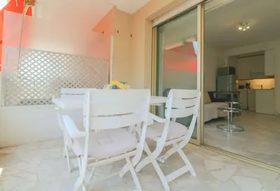 a white table and chairs in a room at Le Navarre By ApiRent #Terrasse #Ascenseur #Wifi in Cannes