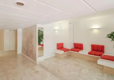 a waiting room with red seats in a building at Le Navarre By ApiRent #Terrasse #Ascenseur #Wifi in Cannes