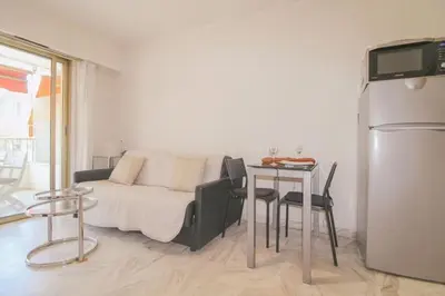 a living room with a couch and a table at Le Navarre By ApiRent #Terrasse #Ascenseur #Wifi in Cannes
