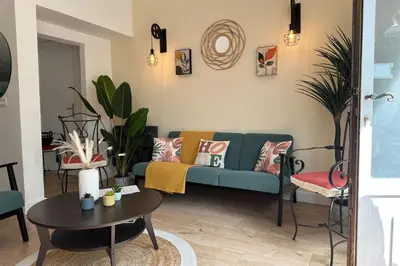 a living room with a blue couch and a table at Spacious duplex near the city center of Cannes in Cannes