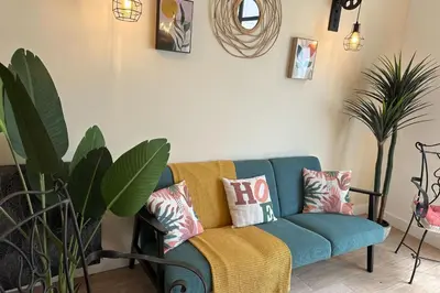 a living room with a blue couch with pillows at Spacious duplex near the city center of Cannes in Cannes
