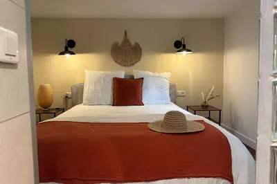 a bedroom with a bed with a hat on it at Spacious duplex near the city center of Cannes in Cannes