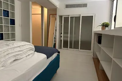 a bedroom with a bed and a sliding glass door at Spacious duplex near the city center of Cannes in Cannes