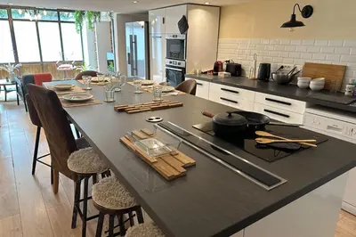 a kitchen with a large table in a kitchen at Spacious duplex near the city center of Cannes in Cannes