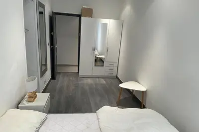 a small bedroom with a bed and a bathroom at Charming T2 in the heart of city center in Cannes