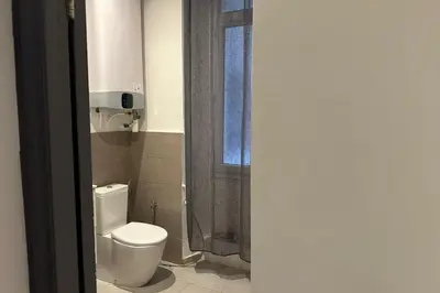 a bathroom with a white toilet and a window at Charming T2 in the heart of city center in Cannes