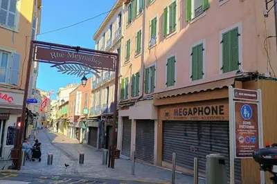 a street with buildings and a sign for a store at Charming T2 in the heart of city center in Cannes