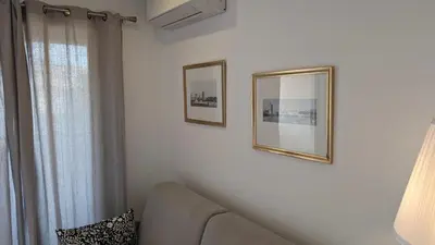 a living room with two pictures on the wall and a couch at Studio neuf centre Cannes 500 m plage in Cannes