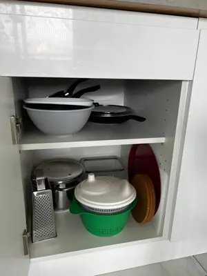 a kitchen shelf with dishes and other kitchen utensils at Studio neuf centre Cannes 500 m plage in Cannes