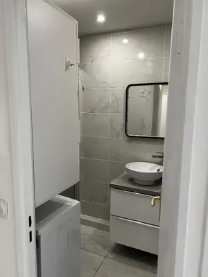 a white bathroom with a sink and a mirror at Studio neuf centre Cannes 500 m plage in Cannes