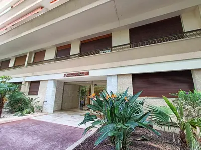 a building with a balcony with plants in front of it at La Résidence Fleuries - Plage in Cannes