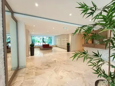 a large lobby with a large marble floor at La Résidence Fleuries - Plage in Cannes