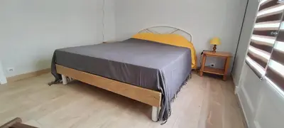 a bed in a room with a wooden floor at T3 spacious 60 m near the beach of Cannes in Cannes