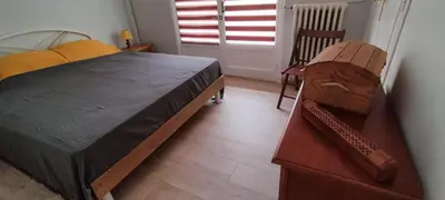 a bedroom with a bed and two chairs and a window at T3 spacious 60 m near the beach of Cannes in Cannes