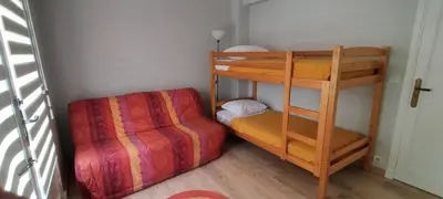 a bunk bed and a couch in a room at T3 spacious 60 m near the beach of Cannes in Cannes