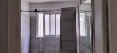 a glass shower in a bathroom with a window at T3 spacious 60 m near the beach of Cannes in Cannes