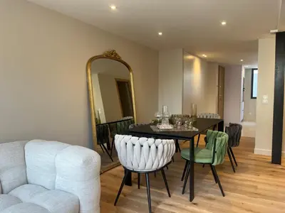 a dining room with a table and a mirror at Nice Living Cannes Plage in Cannes