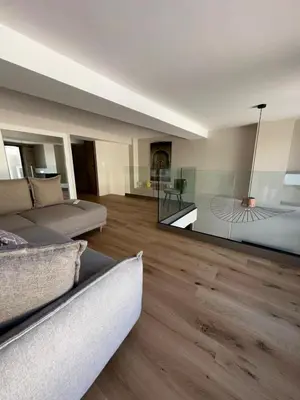 a living room with a couch and a glass wall at Nice Living Cannes Plage in Cannes