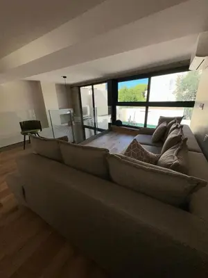a living room with a couch and a large window at Nice Living Cannes Plage in Cannes