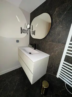 a bathroom with a white sink and a mirror at Nice Living Cannes Plage in Cannes