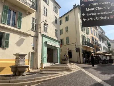 a street with some buildings and a sign on the street at Nice Living Cannes Plage in Cannes