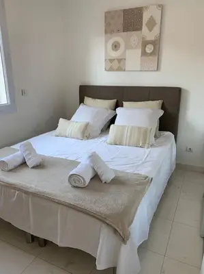 a large white bed with two towels on it at Cannes centre Villa piscine spa in Cannes