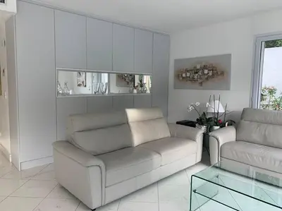 a living room with two couches and a glass table at Cannes centre Villa piscine spa in Cannes