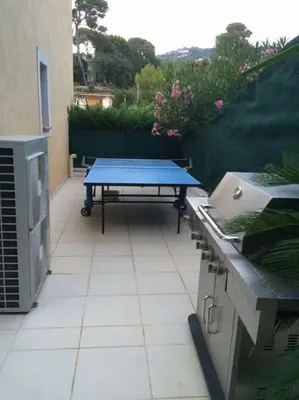 a patio with a blue table and a grill at Cannes centre Villa piscine spa in Cannes