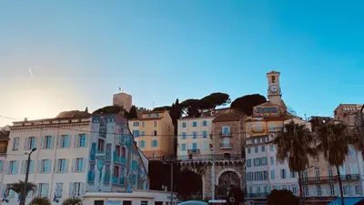 a group of buildings on a hill with a clock tower at Joli 3pièces refait à neuf et très bien situé in Cannes