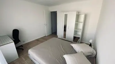 a bedroom with a bed and a desk and a mirror at Joli 3pièces refait à neuf et très bien situé in Cannes