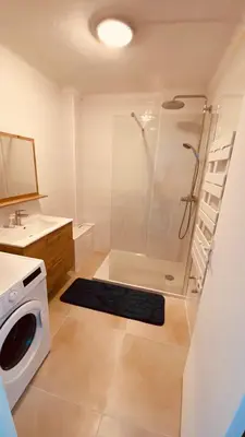 a bathroom with a shower and a washing machine at Joli 3pièces refait à neuf et très bien situé in Cannes