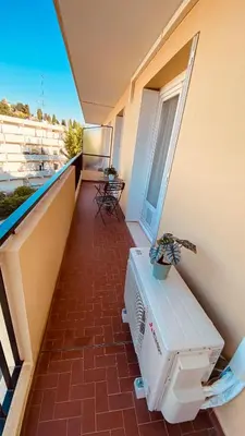 a balcony of a building with a bench and a plant at Joli 3pièces refait à neuf et très bien situé in Cannes