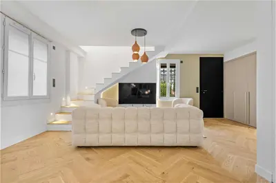 a living room with a white couch and stairs at Luxueuse Villa L'Olivier Cannes 4 chambres jacuzzi in Cannes