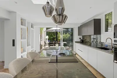 a kitchen and dining room with a table and chairs at Luxueuse Villa L'Olivier Cannes 4 chambres jacuzzi in Cannes