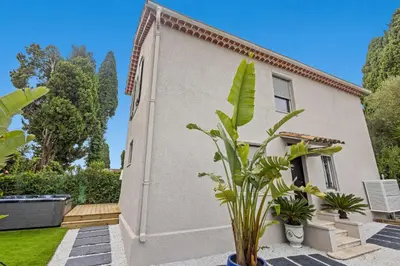 a house with a plant in front of it at Luxueuse Villa L'Olivier Cannes 4 chambres jacuzzi in Cannes